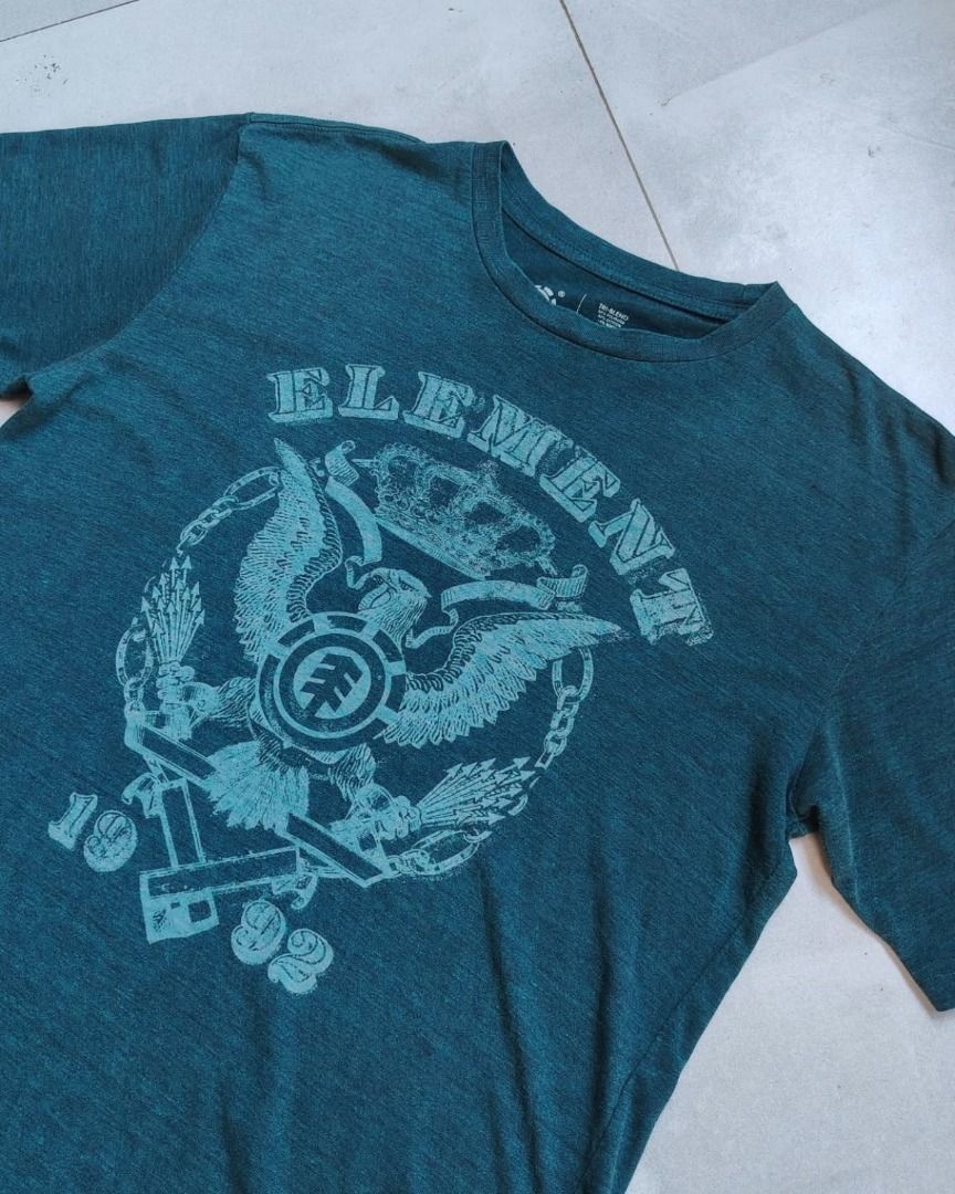 Element Skateboards Graphic Tee Dark Teal (Category: Tshirts & Polo Shirts ) located in Bauang. Submitted by wornskript (Listing ID 1470481403, Image 1). Description: Element Skateboards dark teal-green short-sleeve graphic t-shirt Size : L Dimes : 20.5" x 28" Issue : Minimal check last pic - Brand: Element - Color: Dark teal heathered - Design: Large front graphic with eagle, crown, and 1992 branding - Details: Crew neck, short sleeves, red logo