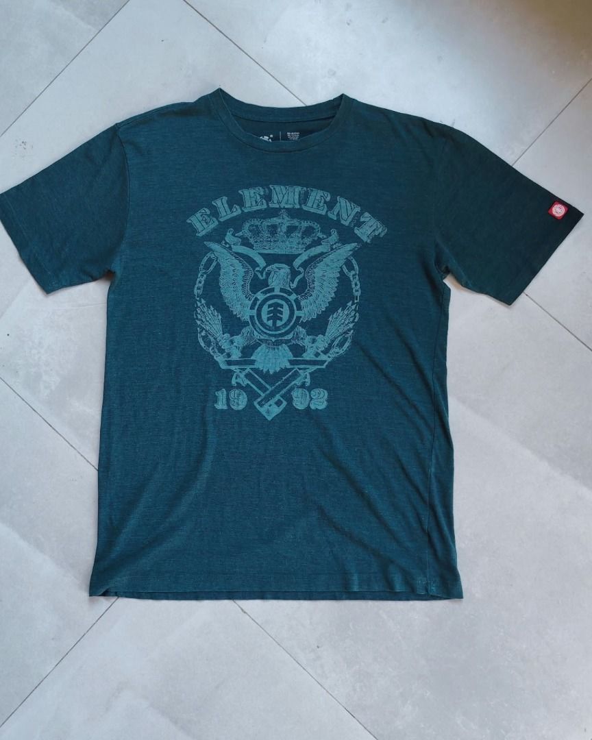 Element Skateboards Graphic Tee Dark Teal (Category: Tshirts & Polo Shirts ) located in Bauang. Submitted by wornskript (Listing ID 1470481403, Image 2). Description: Element Skateboards dark teal-green short-sleeve graphic t-shirt Size : L Dimes : 20.5" x 28" Issue : Minimal check last pic - Brand: Element - Color: Dark teal heathered - Design: Large front graphic with eagle, crown, and 1992 branding - Details: Crew neck, short sleeves, red logo