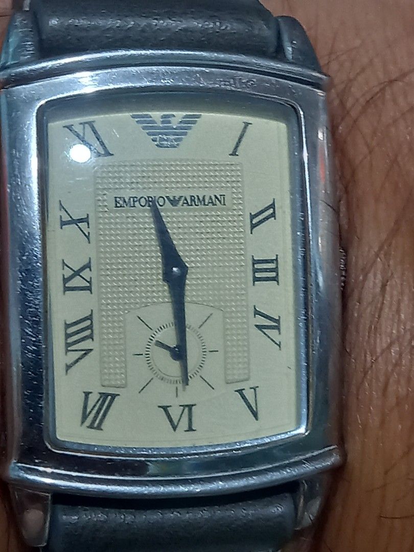 Emporio Armani Rectangular Roman Dial Leather Strap Watch (Category: Women's Watches) located in Subic. Submitted by regiegabriel29 (Listing ID 1470373827, Image 1). Description: - Brand: Emporio Armani - Style: Classic rectangular dress watch - Dial: Textured cream with Roman numerals and sub-dial at 3 o'clock - Case: Silver-tone stainless steel - Strap: Dark grey leather with contrast white stitching and standard buckle clasp - Condition: Pre-l