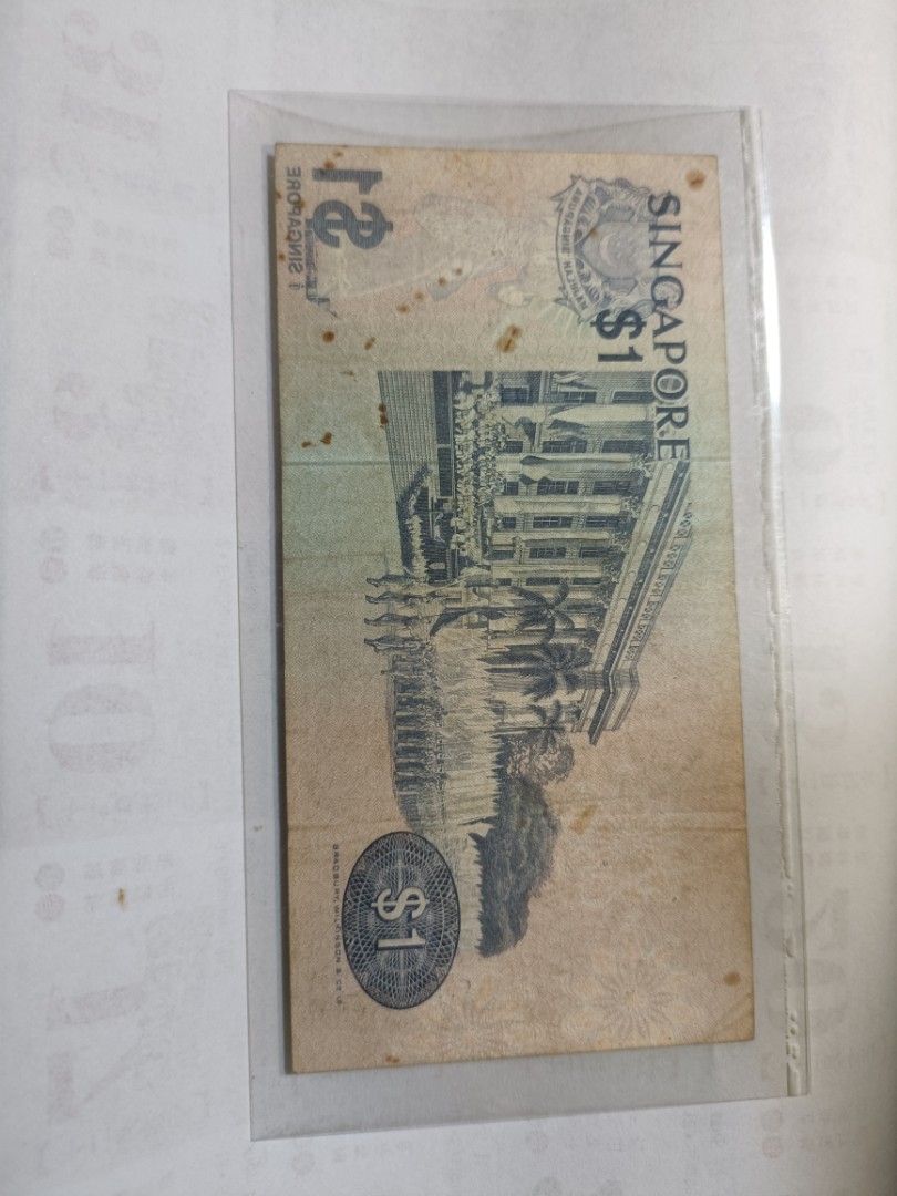 Error note (Category: Currency) located in Singapore. Submitted by alantang1674 (Listing ID 1470497545, Image 2). Description: - Singapore $1 banknote from the iconic Bird Series - Features Black-naped tern design on the front and government building on the back - Serial number: D 40 202292 - Includes Bradbury Wilkinson and Co printer mark - Well-protected inside a clear plastic sleeve.
