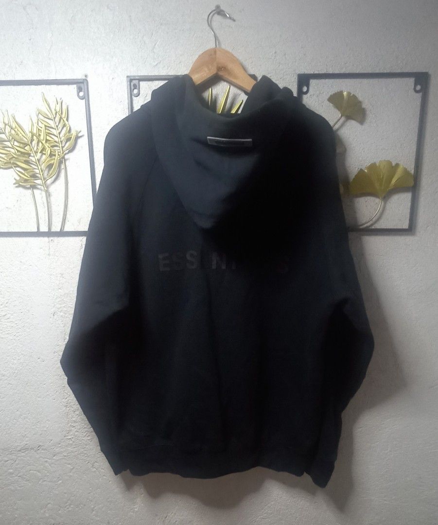 Essentials Hoodie (Category: Hoodies) located in Kawit. Submitted by deidzdzn (Listing ID 1470463930, Image 3). Description: Essentials Fear of God zip-up hoodie in black. Size XL. Measures 25 inches width by 28 inches length. Full front zip, hood with rubber brand patch on the back. Essentials logo printed on the left sleeve and back. ISSUE: NO WASH TAG OFF/LEGIT.