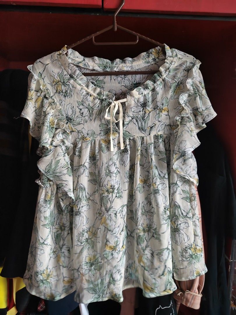 EVALT Floral Ruffle Blouse (Category: Blouses) located in Caloocan City. Submitted by MovesLikeJeager (Listing ID 1470389687, Image 1). Description: EVALT floral blouse in white with green and yellow flowers. Pleated fabric with short ruffled sleeves. Scoop neckline with a drawstring tie in front. Lightweight and flowy material. Easy to match with jeans or skirts for daily wear. Tag shows 100% polyester..
