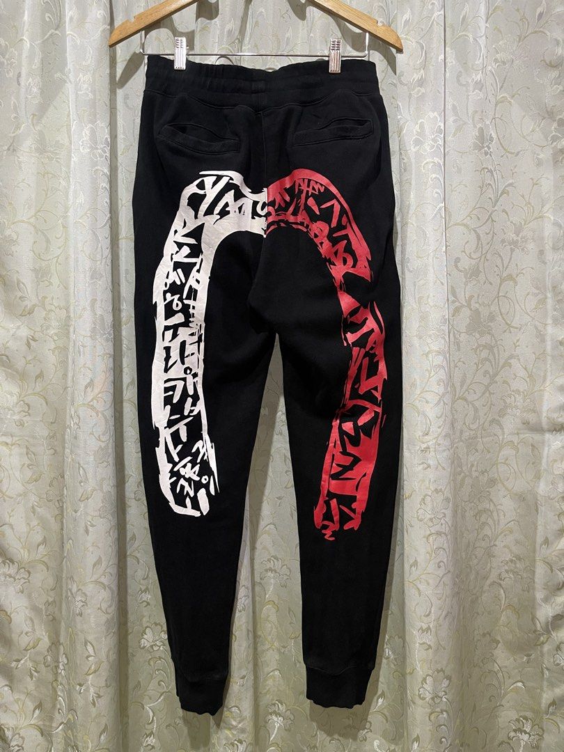 Evisu Black Graphic Sweatpants Size 100 L (Category: Joggers) located in Iligan City. Submitted by goldielooks143 (Listing ID 1470477695, Image 1). Description: - Brand: Evisu - Color: Black - Size: 100 (Large) - Design: White & red graphic print on back legs with small red logo embroidery near the front pocket - Comfort: Soft fleece lining on the inside - Fit: Drawstring waist and ribbed ankle cuffs - Model Code: EQ5UZPL - DM for measurements or