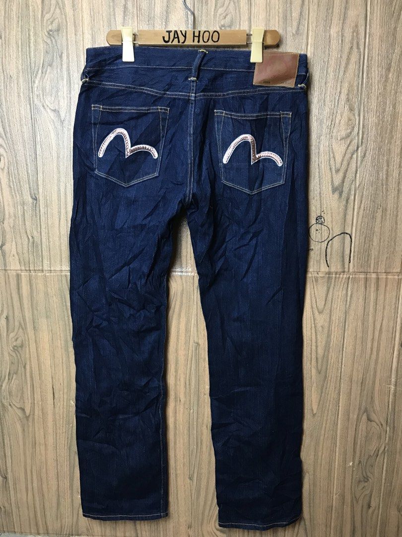 Evisu Dark Wash Denim Jeans (Category: Jeans) located in Aloguinsan. Submitted by jayhooukay (Listing ID 1470475208, Image 1). Description: - Brand: Evisu - Wash: Dark wash, premium heavy denim - Fit: Straight leg - Details: Classic button fly and contrast stitching - Back Pockets: Distinctive bronze-tone embroidered gulls - Cuffs: Selvedge denim with red, white, and navy ticking - Branding: Leather patch on the back waistband.