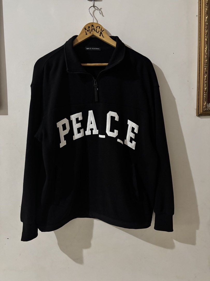 Eye_C Peacebird Black Quarter Zip Sweatshirt (Category: Coats, Jackets and Outerwear) located in Kalibo. Submitted by mack29 (Listing ID 1470351502, Image 1). Description: - Brand: Eye_C Peacebird - Color: Black with large white embroidered 'PEACE' lettering across the chest - Material: Comfortable waffle-knit textured fabric - Design: High collar with zipper closure and black pull tab, small upper back logo detail - Fit: Ribbed cuffs and hem - C