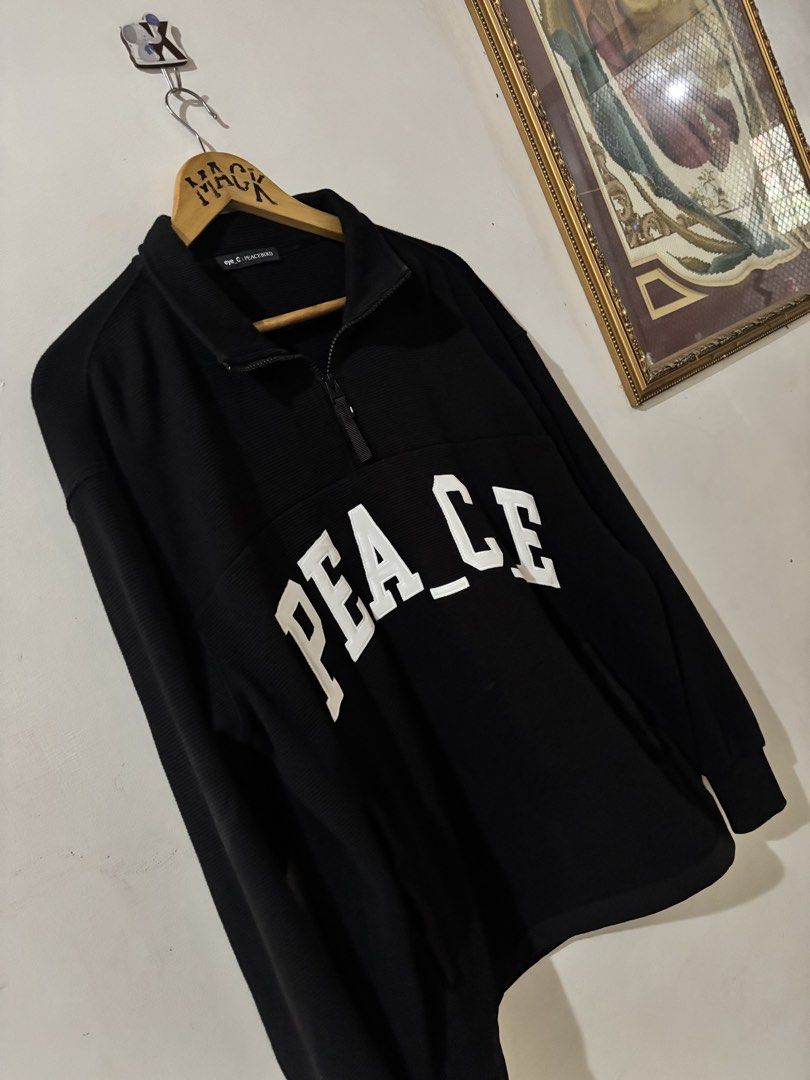 Eye_C Peacebird Black Quarter Zip Sweatshirt (Category: Coats, Jackets and Outerwear) located in Kalibo. Submitted by mack29 (Listing ID 1470351502, Image 3). Description: - Brand: Eye_C Peacebird - Color: Black with large white embroidered 'PEACE' lettering across the chest - Material: Comfortable waffle-knit textured fabric - Design: High collar with zipper closure and black pull tab, small upper back logo detail - Fit: Ribbed cuffs and hem - C