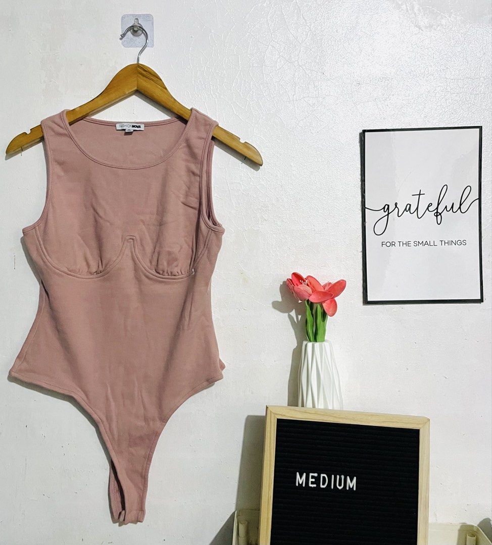 Fashion Nova Ribbed Bodysuit (Category: Sleeveless) located in Caloocan City. Submitted by lovemyclothes21 (Listing ID 1470373962, Image 1). Description: - Brand: Fashion Nova - Item: Ribbed Bodysuit - Color: Dusty Rose - Size: Medium - Design: Scoop neckline with underwire cup detailing and sleeveless cut - Closure: Standard snap closure at the bottom - Material: Stretchy ribbed fabric.