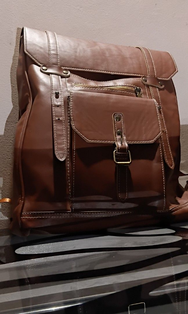 Faux Leather Backpack (Unbranded) (Category: Backpacks) located in Las Pinas. Submitted by randomstuff.ph (Listing ID 1470456442, Image 1). Description: FEATURES - Spacious - Various compartments for keeping small items CONDITION: Lightly used with slight flaws, as shown in the images YEAR BOUGHT: 2023.