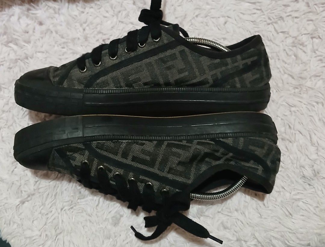 Fendi FF Zucca Print Canvas Low Top Sneakers (Category: Sneakers) located in Andop. Submitted by nzrhcollection (Listing ID 1470456879, Image 2). Description: - Brand: Fendi - Style: Low-top sneakers - Material: Black and brown FF Zucca print canvas with rubber toe caps - Details: Black laces, textured midsoles with embossed Fendi Roma branding on heels, and Italian-made gum soles - Condition: Visible signs of wear on the soles and inner heels - 