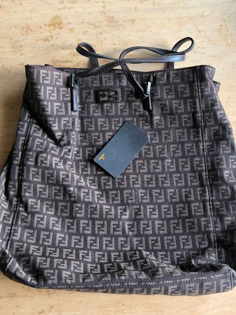 Fendi Zucchino Tote Bag (Category: Tote Bags) located in Manila. Submitted by gutierrez23265 (Listing ID 1470448162, Image 2). Description: - Fendi Zucchino canvas tote bag in dark brown and beige -KAYO NALANG BAHALA MAGCHECK AS IS NALANG PO SIYA - Classic all-over Fendi monogram pattern - Comfortable double leather shoulder straps - Secure top-zip closure with a spacious dark brown fabric-lined interior - Includes internal metal logo plate, seri