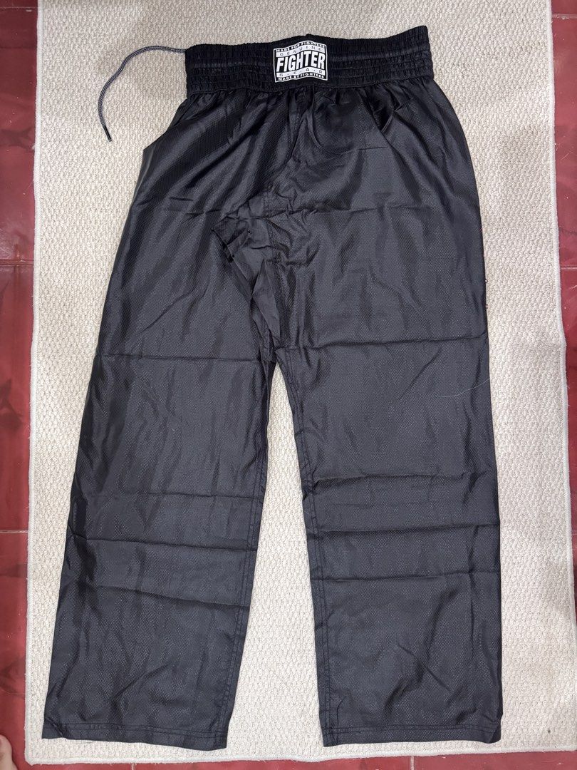 Fighter Gear Black Kickboxing Martial Arts Pants (Category: Combat Sports) located in Valenzuela. Submitted by crabncorn (Listing ID 1470351874, Image 1). Description: - Brand: Fighter Gear - Color: Black - Size: R180 - Material: Lightweight fabric with subtle grid pattern - Waist: Elastic with adjustable drawstring - Details: Branded patch on front waist - Condition: Clean, ready for training or sparring.