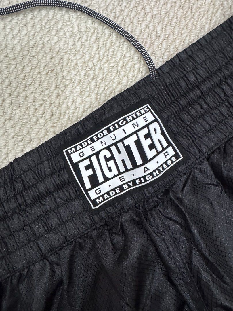 Fighter Gear Black Kickboxing Martial Arts Pants (Category: Combat Sports) located in Valenzuela. Submitted by crabncorn (Listing ID 1470351874, Image 2). Description: - Brand: Fighter Gear - Color: Black - Size: R180 - Material: Lightweight fabric with subtle grid pattern - Waist: Elastic with adjustable drawstring - Details: Branded patch on front waist - Condition: Clean, ready for training or sparring.