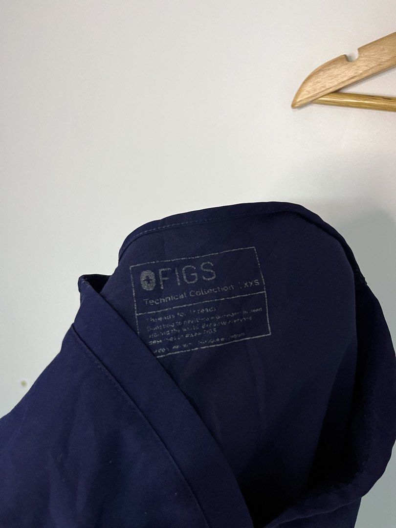 FIGS Technical Collection Navy Blue Scrub Top XXS (Category: Activewear) located in Dasmarinas. Submitted by thriftedbygii (Listing ID 1470532980, Image 2). Description: - Brand: FIGS (Technical Collection) - Color: Dark Navy Blue - Size: XXS - Style: V-neck with short sleeves and two lower front patch pockets - Details: Subtle FIGS logo tag on the right pocket - Condition: Excellent, clean, well-kept with zero stains or fading - Ideal for: Nurse