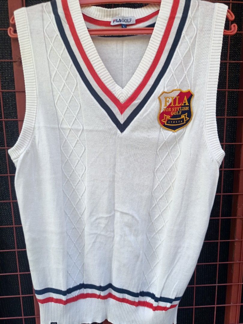 Fila (Category: Vests) located in Aroroy. Submitted by vin2za06 (Listing ID 1470349694, Image 3). Description: The image shows a white Fila Golf knit V-neck sweater vest with red and navy trim and a "Fila For Stylish Golf Italia" crest patch on the chest..