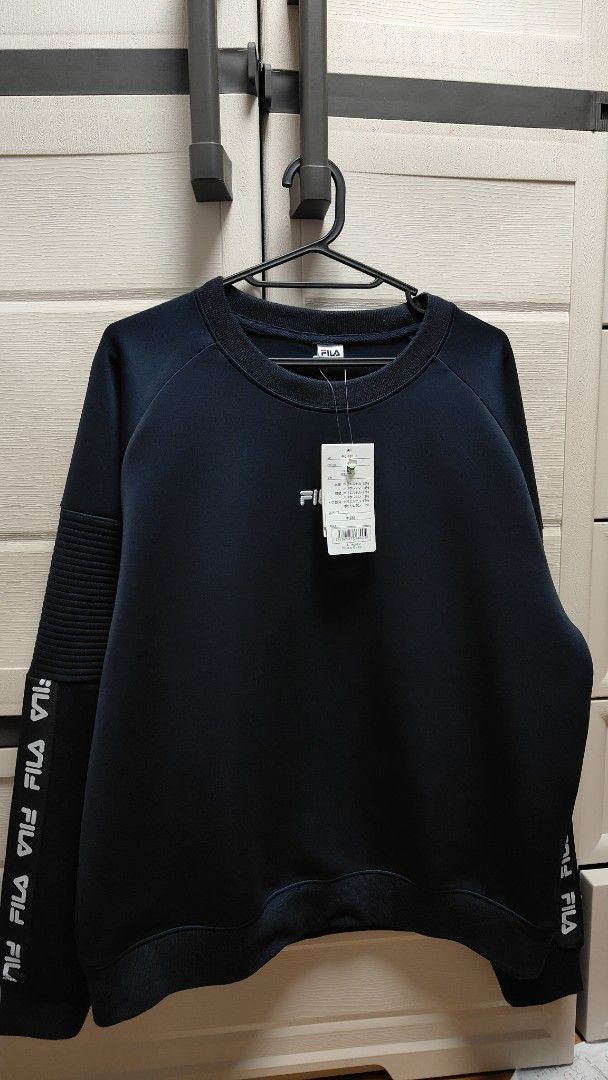 Fila Dark Blue Sweatshirt with Logo Sleeves (Category: Coats, Jackets and Outerwear) located in Manila. Submitted by nel0928 (Listing ID 1470493626, Image 2). Description: Brand new Fila dark blue crewneck sweatshirt with tags attached. Features a relaxed fit, embroidered chest logo, and cool branded tape down both sleeves. Comfortable everyday wear that pairs easily with jeans or joggers..