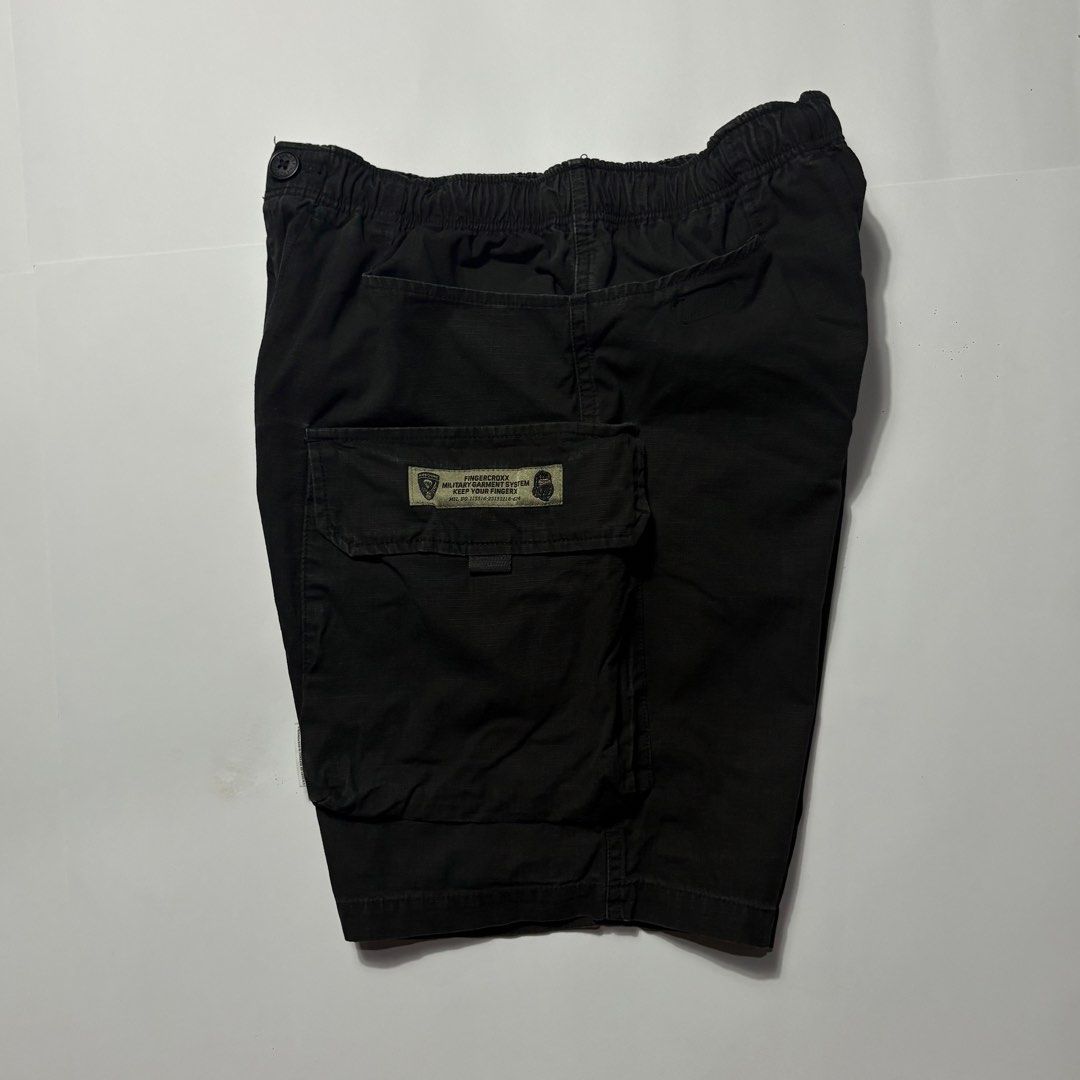 Fingercrox Military Cargo Shorts Black (Category: Shorts) located in San Fernando. Submitted by lumang_gamit (Listing ID 1470398016, Image 2). Description: - Brand/Style: Fingercrox military-style black cargo shorts - Material: Heavy-duty cotton fabric - Waistband: Comfortable elastic waistband with button closure - Storage: Multiple utility pockets on the sides for extra storage - Details: Graphic text print on left cargo pocket and woven milita