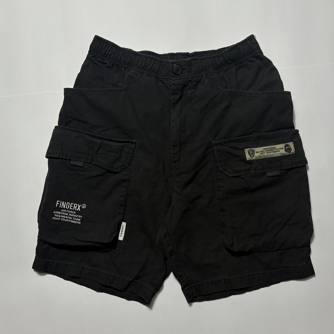 Fingercrox Military Cargo Shorts Black (Category: Shorts) located in San Fernando. Submitted by lumang_gamit (Listing ID 1470398016, Image 1). Description: - Brand/Style: Fingercrox military-style black cargo shorts - Material: Heavy-duty cotton fabric - Waistband: Comfortable elastic waistband with button closure - Storage: Multiple utility pockets on the sides for extra storage - Details: Graphic text print on left cargo pocket and woven milita