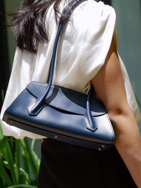 Fino Leatherware Mini Yorker Navy Blue Shoulder Bag (Category: Shoulder Bags) located in Quezon City. Submitted by cheekbuns (Listing ID 1470364702, Image 2). Description: - Brand: Fino Leatherware - Style: Structured east west shoulder bag 12 x 5.5 x 4.5 x 10” - Material: Premium textured blue leather - Features: Double top handles, clean flap closure, pristine interior and exterior - Inclusions: Original dust bag and attached brand tag.