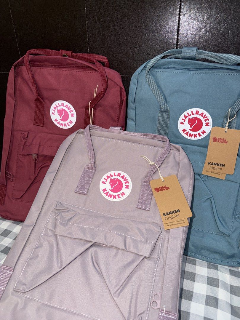 Fjallraven Kanken Backpacks (Category: Backpacks) located in Makati City. Submitted by gigidvd (Listing ID 1470446807, Image 3). Description: - Color: Red, Blue, Purple - Brand new with a reflective logo - Classic rectangular shape with dual top handles.