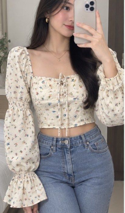 Floral Long Sleeve Crop Top with Drawstring (Category: Longsleeves) located in Tabuk. Submitted by zenwolf-1867 (Listing ID 1470531887, Image 1). Description: - Color: Cream with multicolored floral print - Fit: Crop top, hits right above the waist - Sleeves: Long balloon sleeves with ruffled cuffs - Neckline: Square neckline with front drawstring tie - Details: Elastic shoulders and textured crinkled fabric.