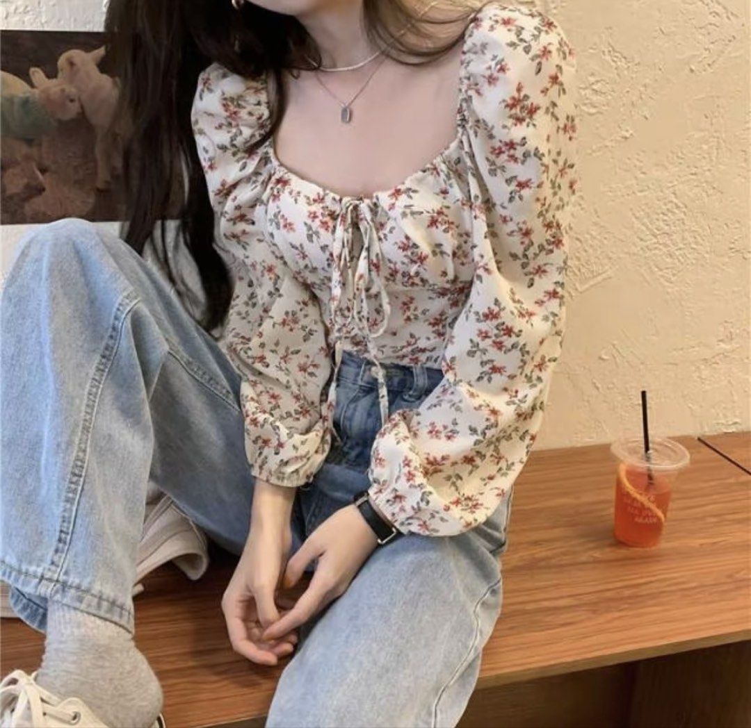 Floral Square Neck Long Sleeve Blouse (Category: Longsleeves) located in Baguio. Submitted by declutterbycys (Listing ID 1470385295, Image 2). Description: - Color/Pattern: White with tiny red floral print - Fit: Slim fit, looks great with denim jeans - Neckline: Square neckline with a cute tie-string detail - Sleeves: Long puffy sleeves with elastic cuffs - Condition: Excellent/Brand New.