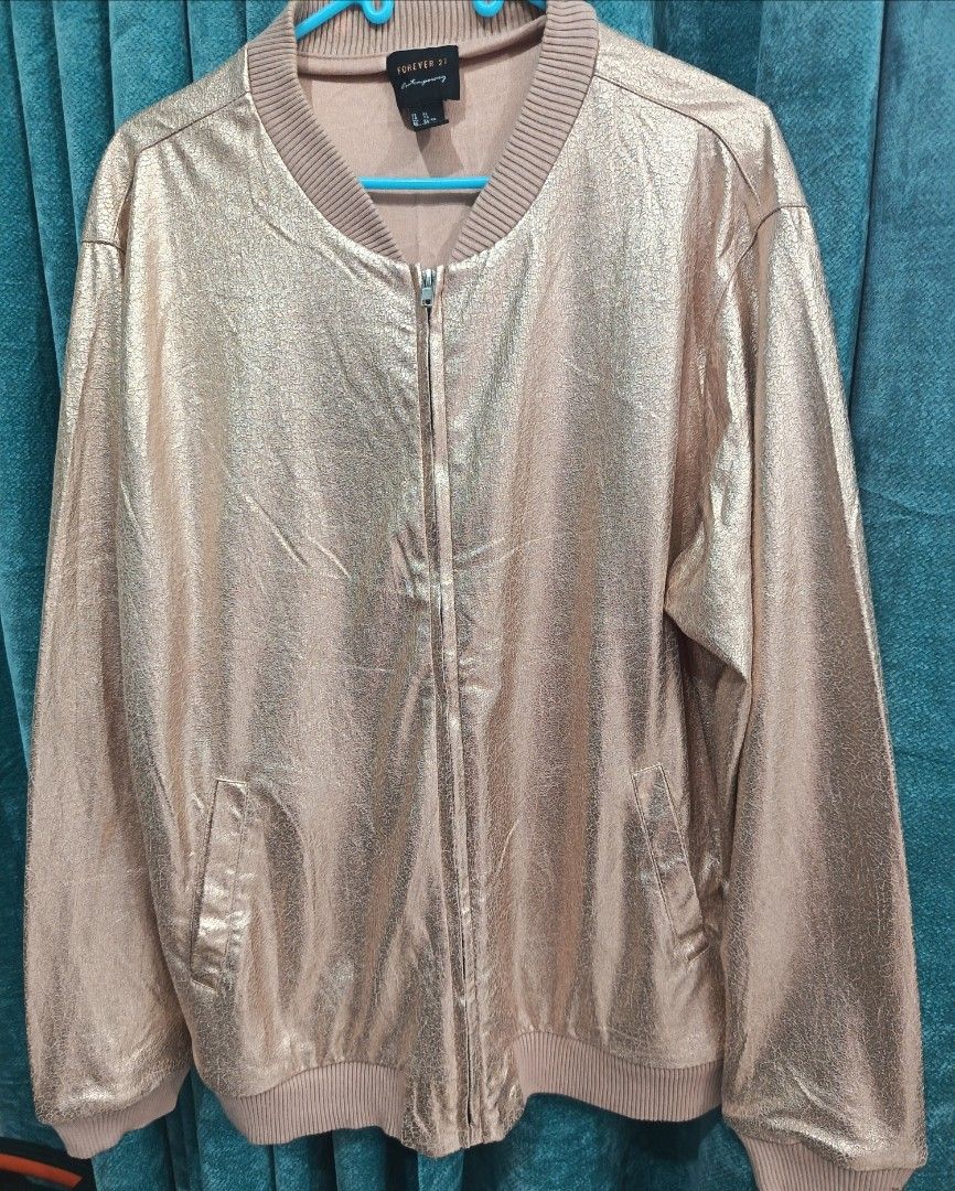 Forever 21 (Category: Coats, Jackets and Outerwear) located in Cavite. Submitted by vin2za06 (Listing ID 1470385677, Image 1). Description: This is a Forever 21 metallic gold bomber jacket featuring a front zip closure, side pockets, and ribbed knit trim on the collar, cuffs, and hem..
