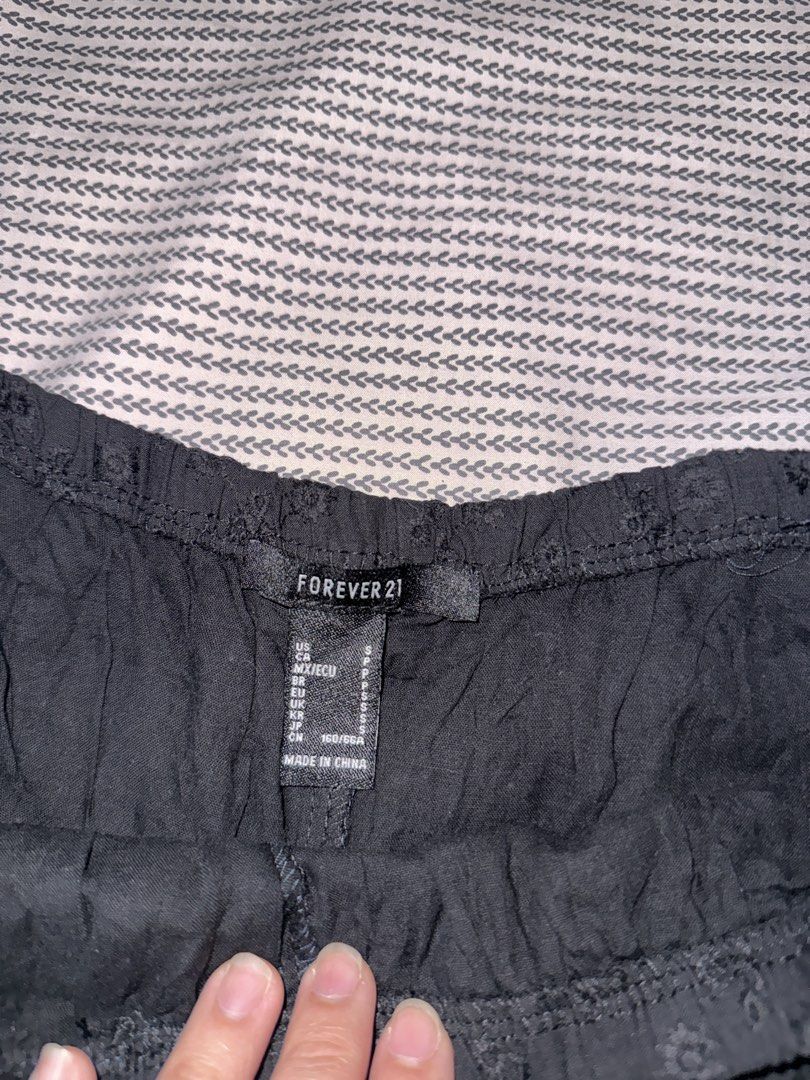 Forever 21 Black Eyelet Ruffle Shorts (Category: Shorts) located in Santa Ana. Submitted by fatikilla (Listing ID 1470378743, Image 2). Description: - Brand: Forever 21 - Size: S (tag indicated) - Color: Black - Design: Allover eyelet pattern with ruffle hem detail - Waist: Elastic waistband for easy pull-on fit - Fabric: Lightweight, ideal for warm weather days - Condition: Excellent.