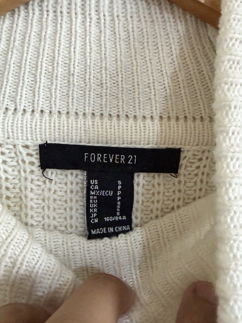 Forever 21 Colorblock Turtleneck Sweater Size S (Category: Longsleeves) located in Manila. Submitted by snipe.shit (Listing ID 1470423545, Image 3). Description: - Brand: Forever 21 - Style: Turtleneck sweater with colorblock stripes (blue, navy, white) and chevron chest pattern - Size: Small - Material: 60% cotton, 40% acrylic (thick knit fabric) - Features: Long sleeves with folded cuffs - Care: Hand wash cold - Condition: Brand new with tag at