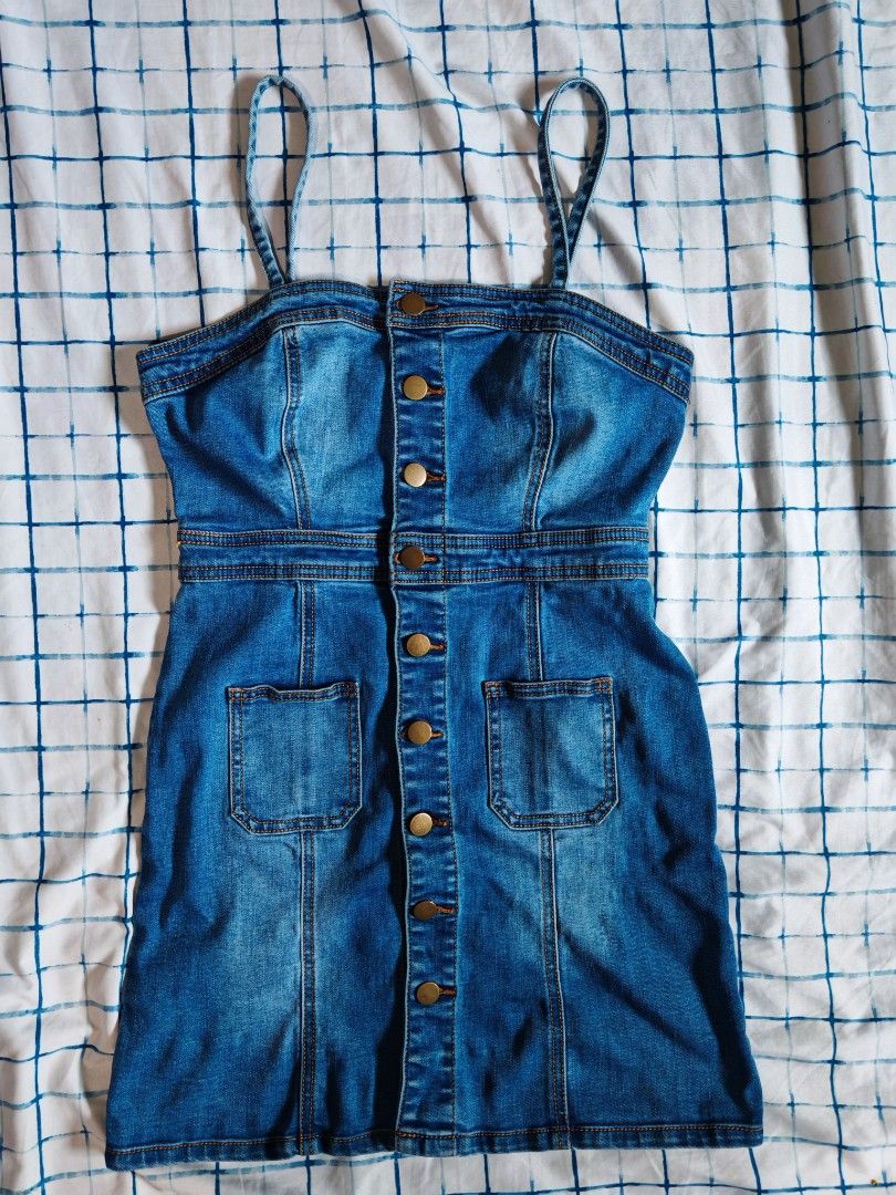 Forever 21 Denim Dress Size S (Category: Dresses) located in Paranaque City. Submitted by MLandCobyApple (Listing ID 1470374495, Image 1). Description: - Brand: Forever 21 - Size: S - Wash: Medium blue denim - Style: Sleeveless with thin straps and structured fit - Details: Front button closure with metallic hardware, contrast stitching - Pockets: Two chest pockets and two front pockets - Never worn - Origin: Made in China.