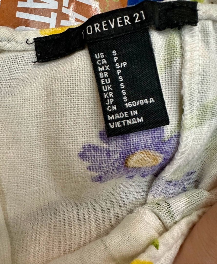 Forever 21 Floral Sundress Size S (Category: Dresses) located in Quezon City. Submitted by decluttering_alot (Listing ID 1470424814, Image 3). Description: - Brand: Forever 21 - Size: S - Color: Cream with yellow & purple floral print - Design: Square neckline, wide ruffle straps, fitted bodice, flared skirt, ruffled hem - Material: Lightweight textured fabric (ideal for warm weather) - Closure: Back zipper RFS: used once, closet cleanup.
