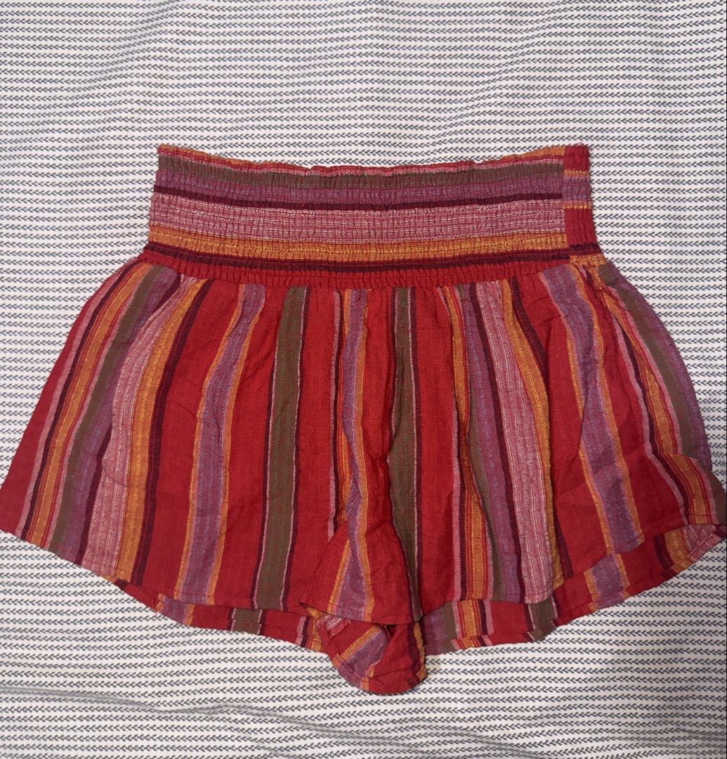 Forever 21 Multi-colored Striped Smocked Shorts Size S (Category: Shorts) located in Santa Ana. Submitted by fatikilla (Listing ID 1470465240, Image 1). Description: - Brand: Forever 21 - Size: Small - Color/Pattern: Red with multicolored vertical stripes - Waistband: Thick smocked elastic for a stretchy, comfortable fit - Design: Flowy, skirt-like silhouette - Fabric: Lightweight and ideal for warm weather.