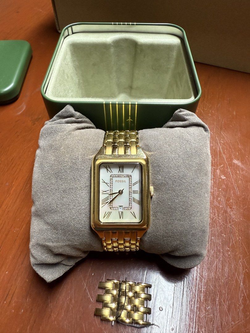 Fossil Gold Tone Rectangular Women's Watch with Box (Category: Women's Watches) located in Paranaque City. Submitted by engrmike (Listing ID 1470350231, Image 1). Description: - Brand: Fossil women's watch - Color/Material: Elegant gold-tone stainless steel link bracelet with deployment clasp - Dial: Rectangular face featuring classic Roman numerals, date window, and sparkling crystal accents - Inclusions: Comes with extra links and the original 