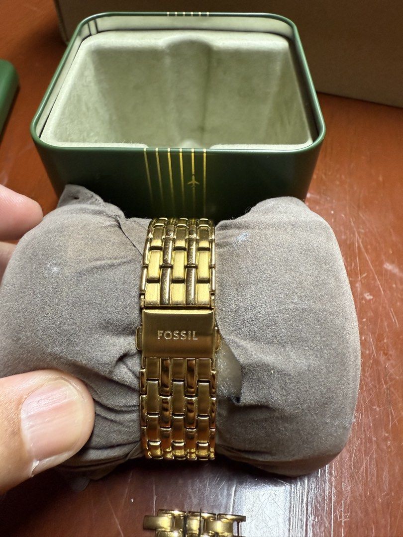 Fossil Gold Tone Rectangular Women's Watch with Box (Category: Women's Watches) located in Paranaque City. Submitted by engrmike (Listing ID 1470350231, Image 2). Description: - Brand: Fossil women's watch - Color/Material: Elegant gold-tone stainless steel link bracelet with deployment clasp - Dial: Rectangular face featuring classic Roman numerals, date window, and sparkling crystal accents - Inclusions: Comes with extra links and the original 