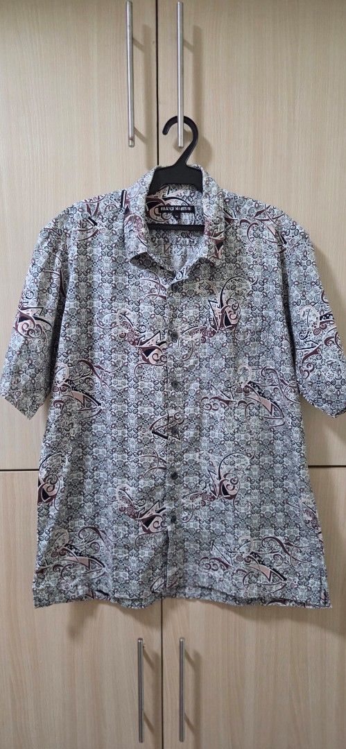 Franz Martine Patterned Short Sleeve Button-Down Shirt Size M (Category: Tshirts & Polo Shirts ) located in Manila. Submitted by doyak (Listing ID 1470412561, Image 1). Description: - Brand: Franz Martine - Size: Medium (M) fits Small too - Design: Intricate abstract pattern in grey, brown, and cream - Features: Standard collar, front button closure, short sleeves with lightweight fabric - Condition: Clean and well-maintained.