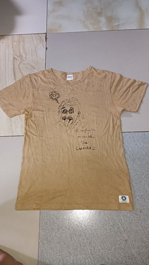 Freenage Brown Albert Einstein Graphic T-Shirt Size M (Category: Tshirts & Polo Shirts ) located in Davao. Submitted by 3stagethrifter (Listing ID 1470451705, Image 1). Description: - Brand: Freenage - Origin: Made in Japan - Size: Medium (tag on collar) - Color: Brown - Design: Albert Einstein graphic print with quote text on front - Details: Small woven label near bottom hem - Fit: Crew neck, short sleeves.