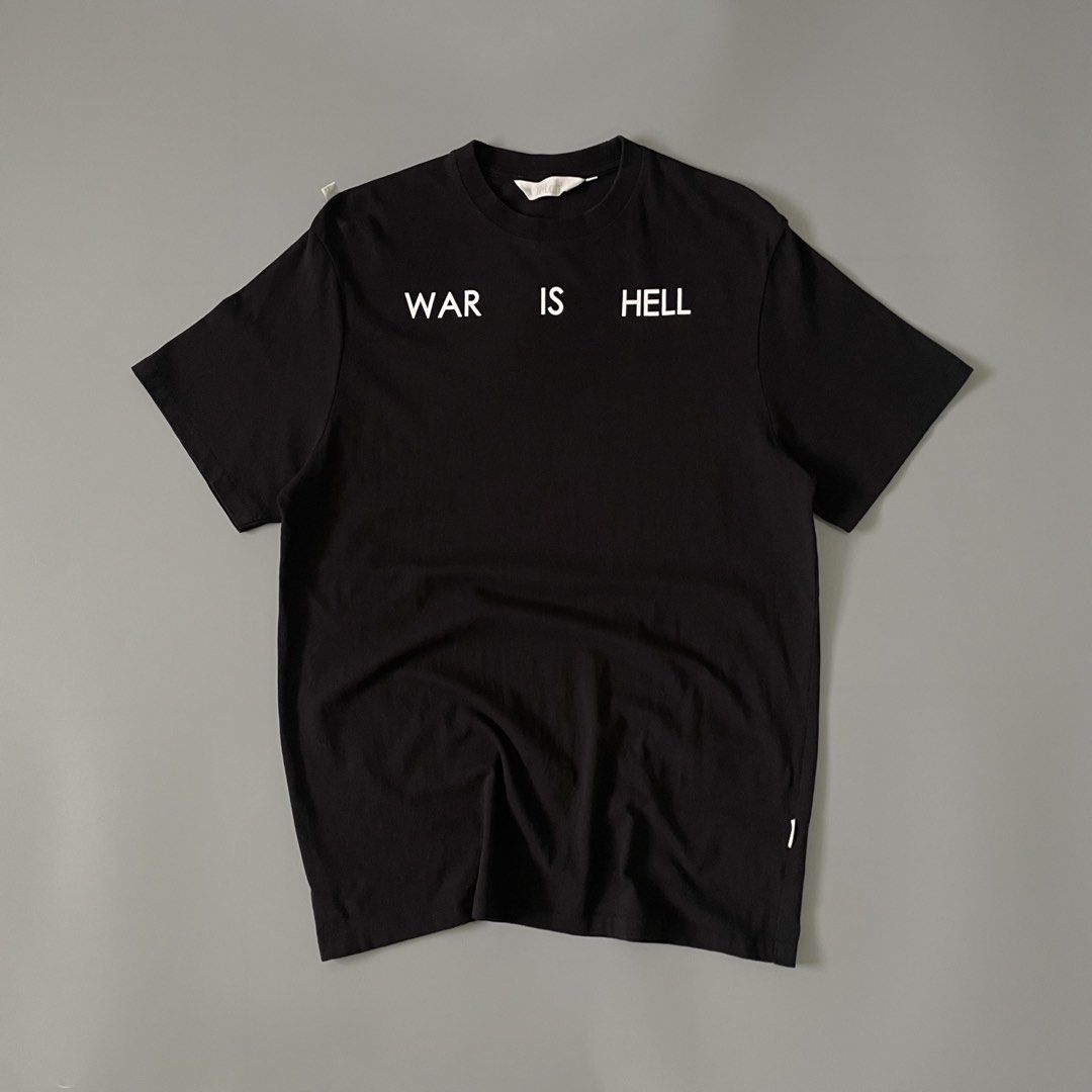 Ftclh Black War Is Hell Flame Graphic T-Shirt (Category: Tshirts & Polo Shirts ) located in Manila. Submitted by allthrift07 (Listing ID 1470400694, Image 1). Description: - Brand: Ftclh - Color: Black - Material: Clean cotton build with standard crew neckline - Front: 'WAR IS HELL' text printed in white across upper chest - Back: Large flaming billiard ball graphic with gradient red, orange, and yellow flames - Details: Small white branding logo