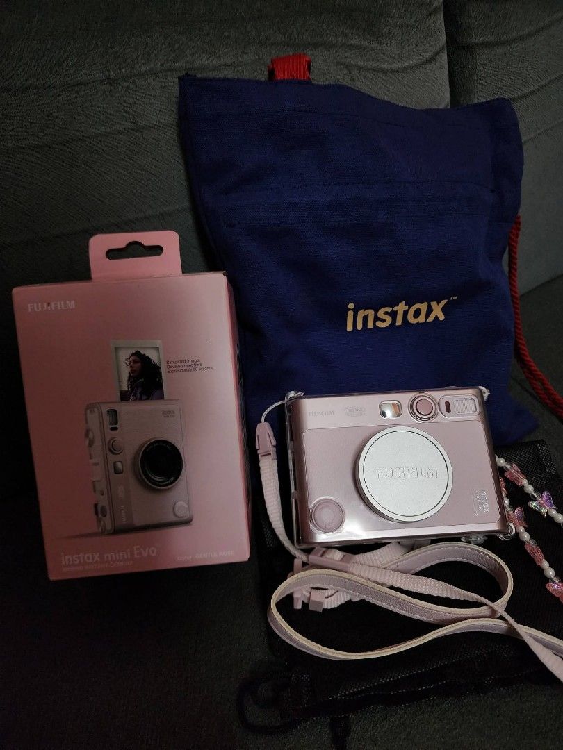 Fujifilm Instax Mini Evo Gentle Rose (Category: Cameras) located in Cavite. Submitted by adsartes (Listing ID 1470425618, Image 1). Description: - Model: Fujifilm Instax Mini Evo (Gentle Rose) - Type: Hybrid Instant Camera - Inclusions: Original box, clear protective casing, matching strap, and blue Instax bag - Condition: Everything pictured is included together - Status: Ready to ship, grab it before it's gone!.