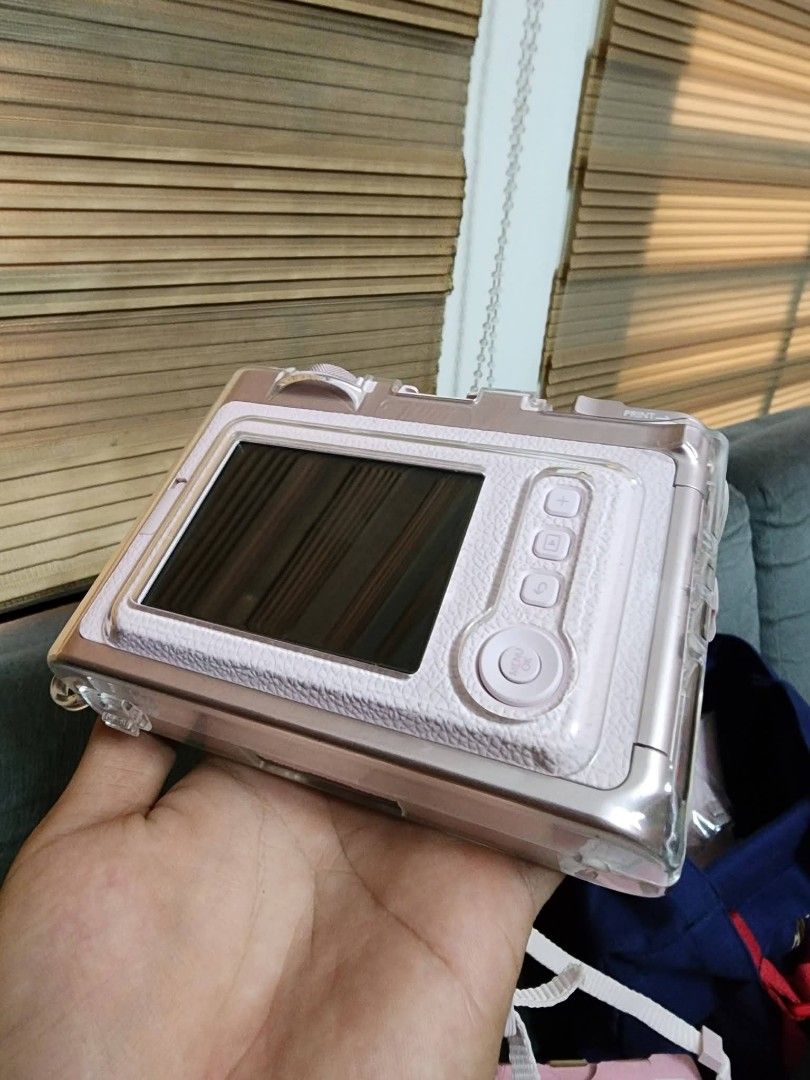 Fujifilm Instax Mini Evo Gentle Rose (Category: Cameras) located in Cavite. Submitted by adsartes (Listing ID 1470425618, Image 3). Description: - Model: Fujifilm Instax Mini Evo (Gentle Rose) - Type: Hybrid Instant Camera - Inclusions: Original box, clear protective casing, matching strap, and blue Instax bag - Condition: Everything pictured is included together - Status: Ready to ship, grab it before it's gone!.