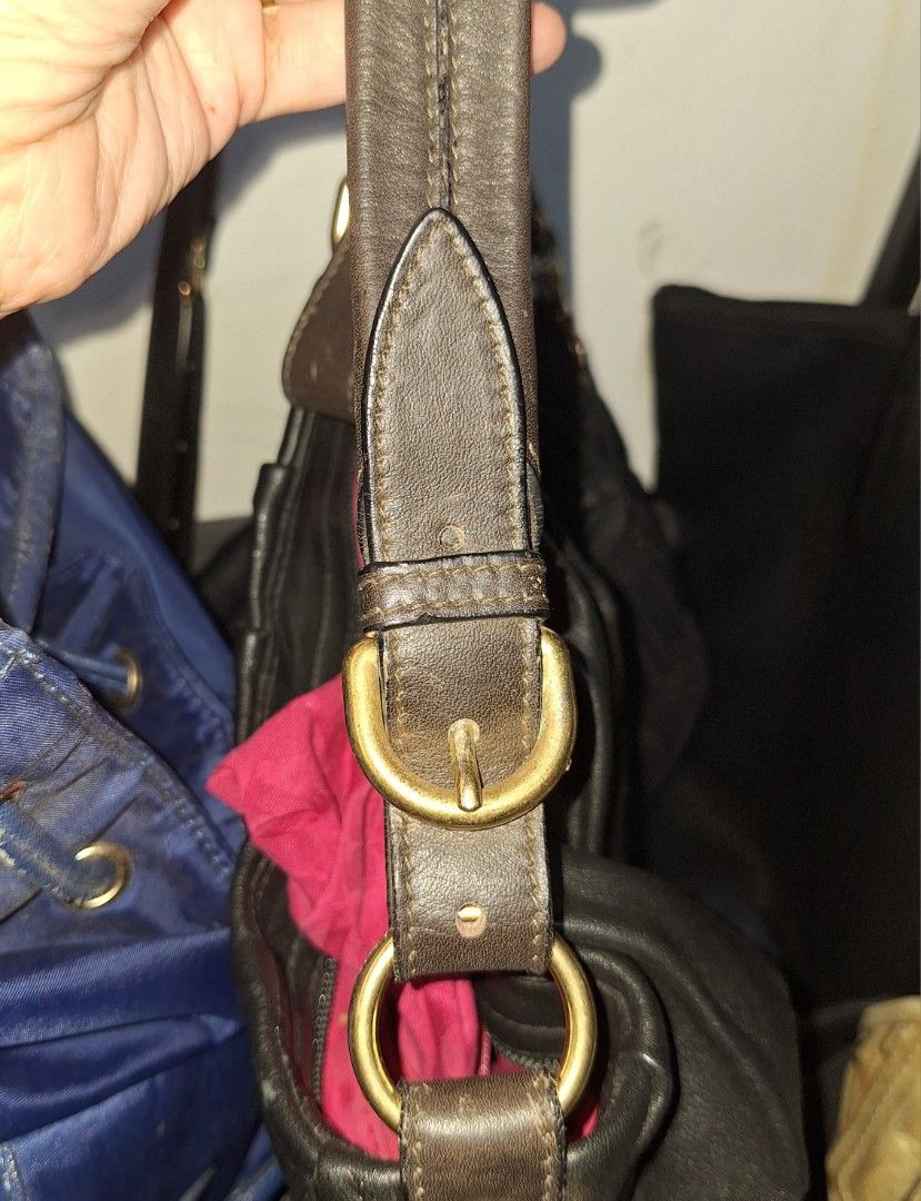 Furla Black Leather Shoulder Bag (Category: Luxury Bags & Wallets) located in Quezon City. Submitted by cloudymay (Listing ID 1470551867, Image 2). Description: - Brand: Furla - Material: Soft black leather with natural slouchy shape - Design: Ruched front body with adjustable buckle strap and brass-tone rings - Interior: Bright pink lining with zippered side pocket and style code F5561 tag - Hardware: Functional zippers with Furla-stamped pull -