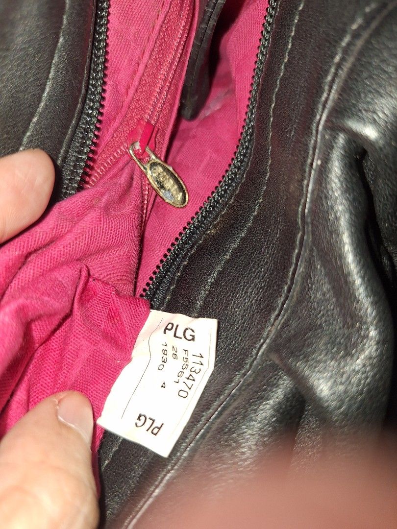 Furla Black Leather Shoulder Bag (Category: Luxury Bags & Wallets) located in Quezon City. Submitted by cloudymay (Listing ID 1470551867, Image 3). Description: - Brand: Furla - Material: Soft black leather with natural slouchy shape - Design: Ruched front body with adjustable buckle strap and brass-tone rings - Interior: Bright pink lining with zippered side pocket and style code F5561 tag - Hardware: Functional zippers with Furla-stamped pull -