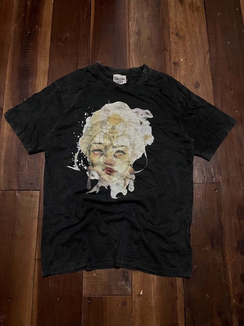 Gallery Dept. Graphic Tee Alone In Silence Black (Category: Tshirts & Polo Shirts ) located in Manila. Submitted by adzwilnams67005 (Listing ID 1470499686, Image 1). Description: - Brand: Gallery Dept. - Color: Washed black - Design: Front artistic portrait with white paint splatter; back layered 'Alone In Silence' lettering in red and metallic gold - Details: Woven brand neck tag with side size tab - Fit: Regular fit with heavy wash fabric style