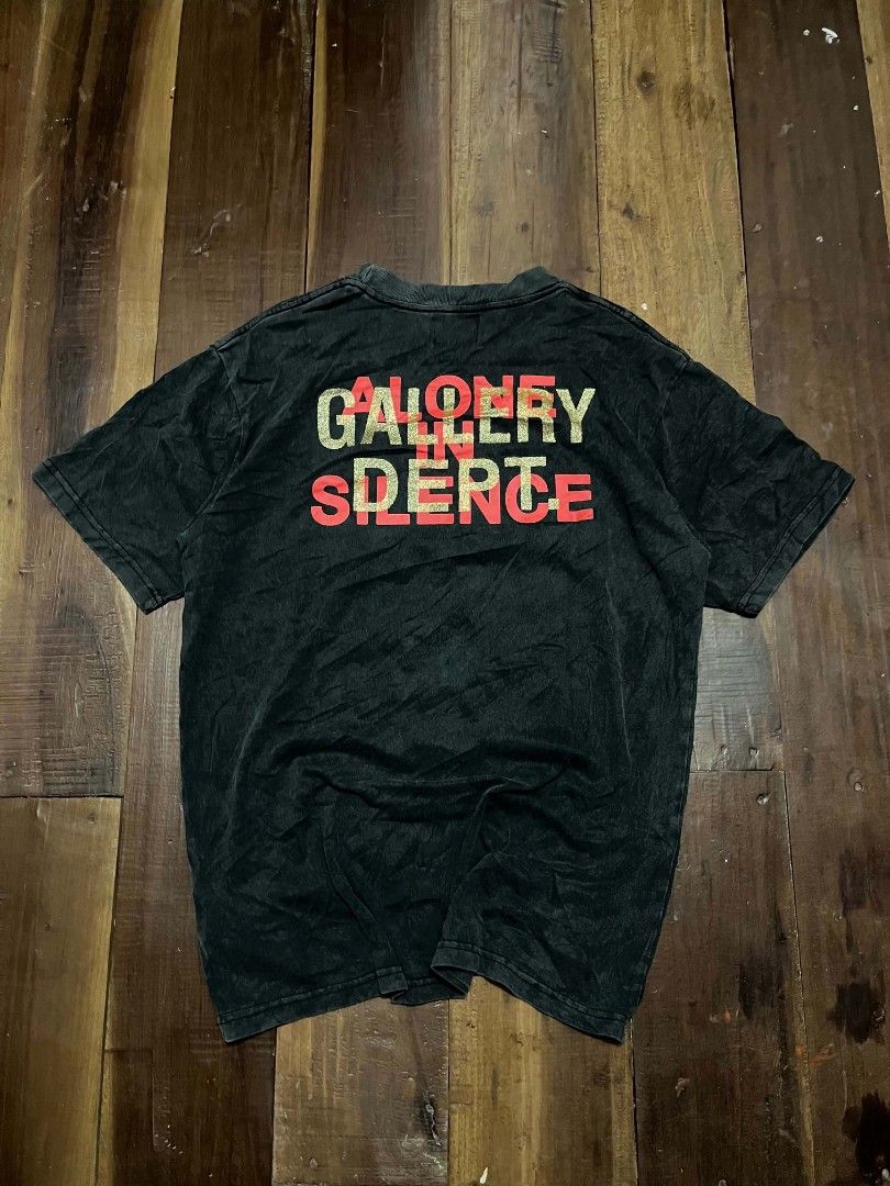 Gallery Dept. Graphic Tee Alone In Silence Black (Category: Tshirts & Polo Shirts ) located in Manila. Submitted by adzwilnams67005 (Listing ID 1470499686, Image 2). Description: - Brand: Gallery Dept. - Color: Washed black - Design: Front artistic portrait with white paint splatter; back layered 'Alone In Silence' lettering in red and metallic gold - Details: Woven brand neck tag with side size tab - Fit: Regular fit with heavy wash fabric style
