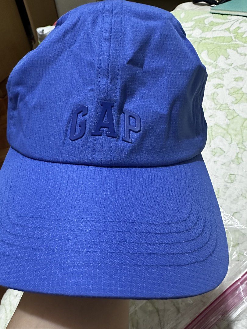 GAP Blue Baseball Cap Adjustable Ripstop Hat (Category: Caps & Hats) located in Balanga. Submitted by jamilbeauty5 (Listing ID 1470463784, Image 1). Description: - Brand: GAP - Color: Blue - Material: 100% polyester ripstop with cotton lining - Design: Embroidered GAP logo on the front - Fit: One size fits most with an adjustable strap at the back - Origin: Made in Vietnam - Care: Machine washable - GUARANTEED AUTHENTIC! .
