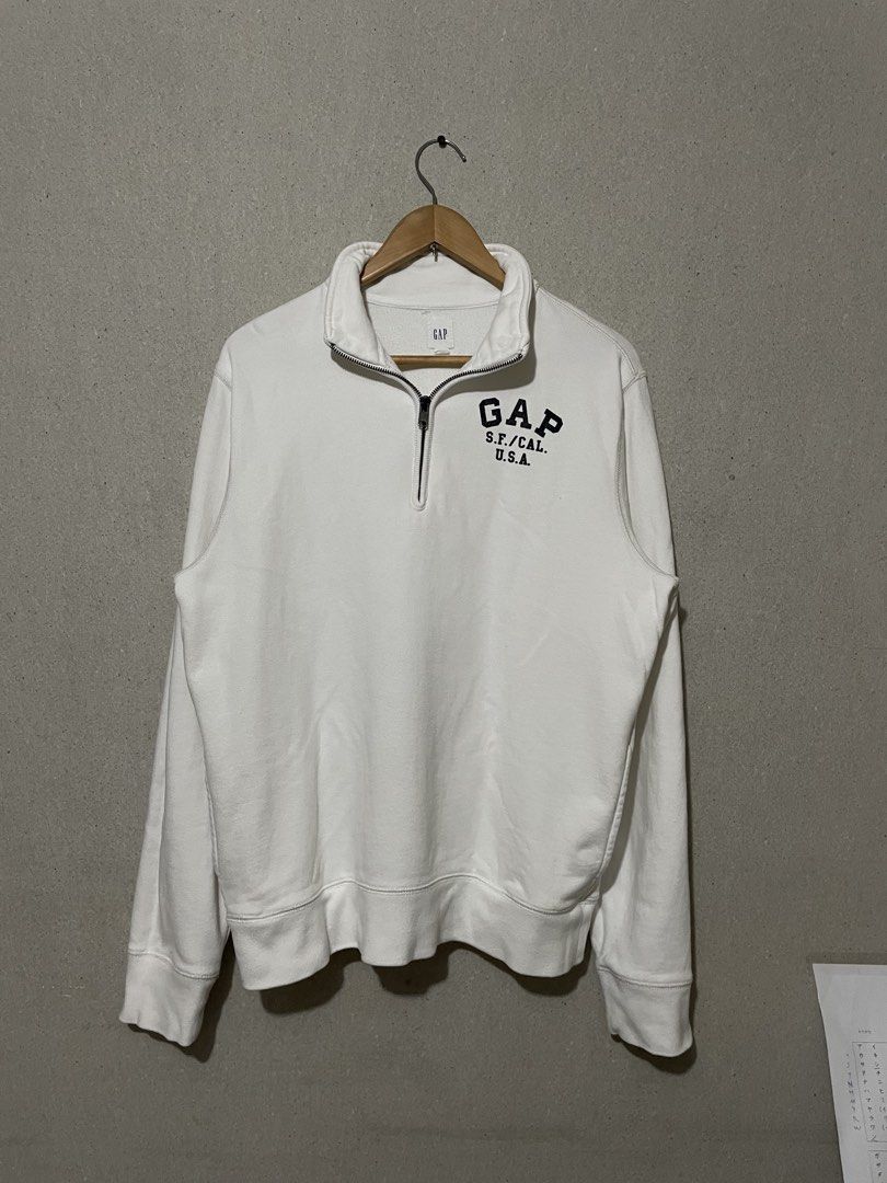 Gap Half Zip Sweatshirt White Size L (Category: Coats, Jackets and Outerwear) located in Antipolo. Submitted by jemiruxd (Listing ID 1470462649, Image 1). Description: - Brand/Style: White Gap half-zip sweatshirt with a stand-up collar - Graphic: Bold black GAP S.F./CAL. U.S.A. print on the chest - Size: L (tag on collar) - Material: 100% cotton - Details: Ribbed cuffs and hem, smooth-working metal zipper - Condition: Clean white fabric, classic 