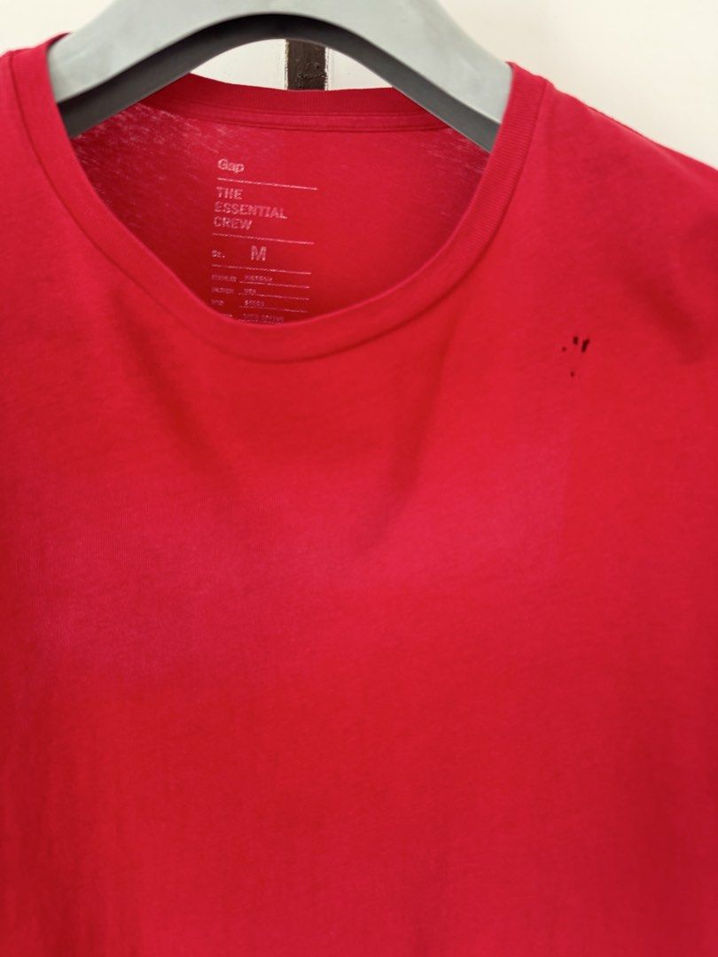 Gap The Essential Crew Red T-Shirt Size M (Category: Shirts) located in Quezon City. Submitted by satisfied_buyer (Listing ID 1470554727, Image 2). Description: - Brand/Item: Gap The Essential Crew T-Shirt - Color: Bright Red - Size: Medium (Regular Fit) - Material: 100% Cotton - Origin: Made in Vietnam - Style Code: 767861 - Condition Note: Has small holes near the collar on the front left chest Decluttering Shoulders 47m Chest 48m Length 70m.