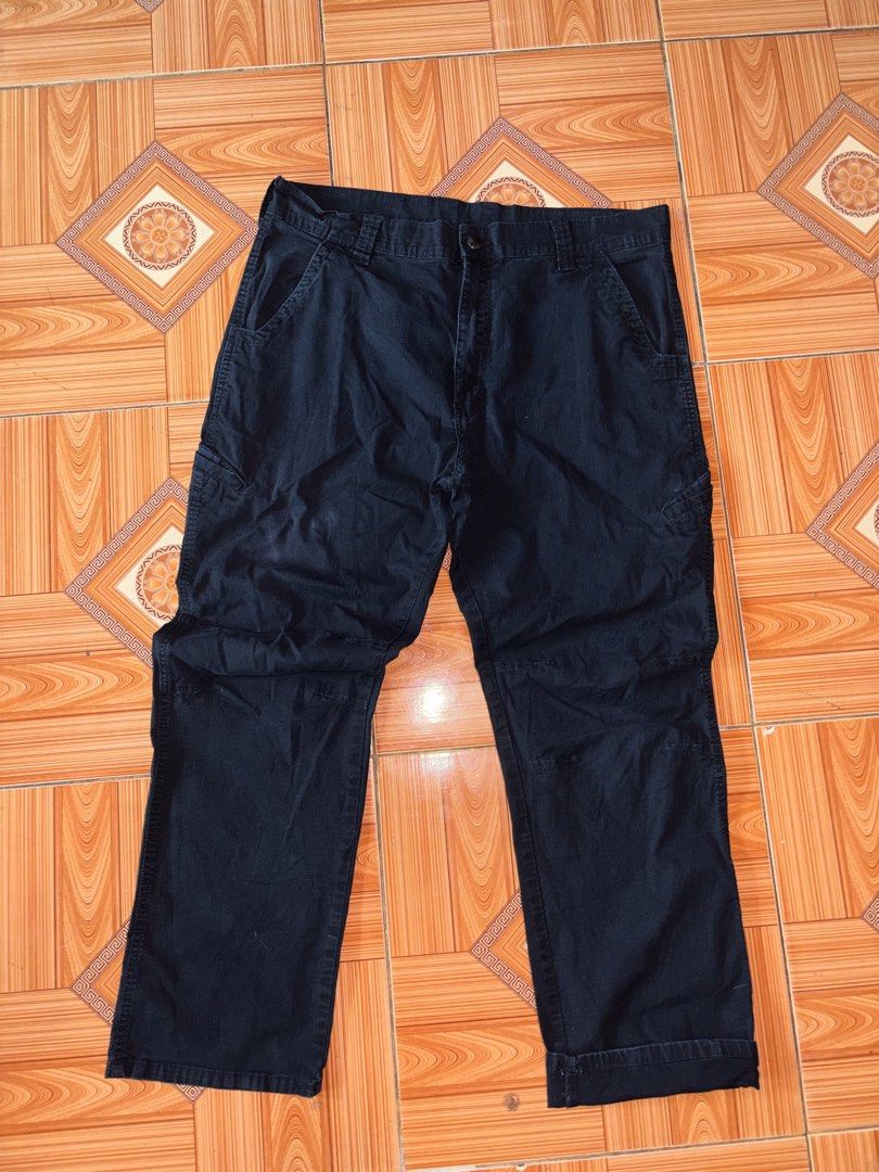 Genuine Dickies Black Cargo Work Pants (Category: Trousers) located in Polomolok. Submitted by rrthrift (Listing ID 1470503230, Image 1). Description: - Brand: Genuine Dickies - Color: Dark Navy Blue Size 36 length 41 - Material: Heavy-duty cotton with ripstop texture - Pockets: Multiple utility pockets on sides and back - Closure: Standard button and zipper fly - Style: Classic utility workwear.