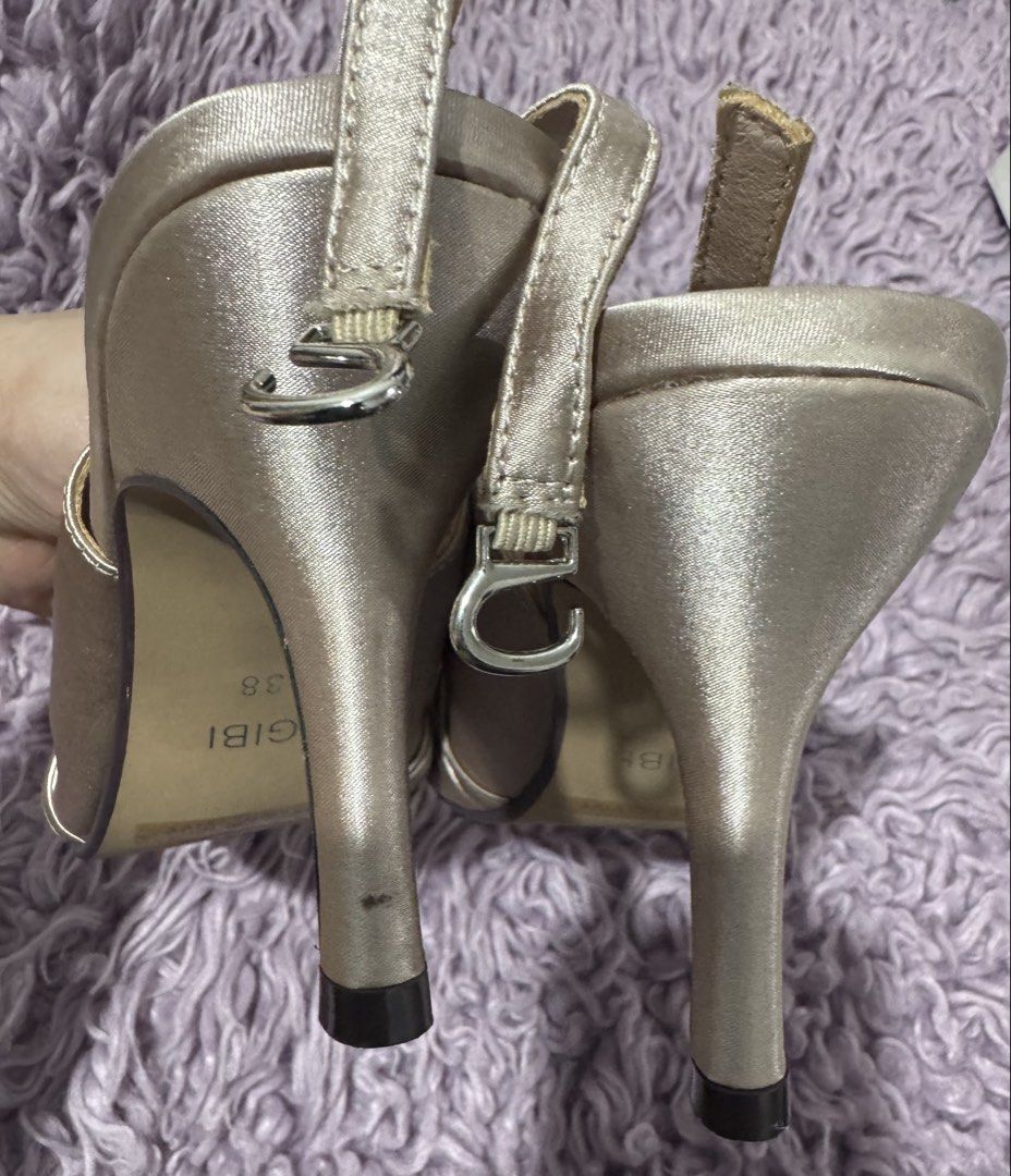 Gibi Gold Satin Slingback Heels Size 38 (Category: Heels) located in Cabanatuan. Submitted by dyosasalupa (Listing ID 1470507875, Image 1). Description: - Brand: Gibi - Style: VIVY (Gold Satin Slingback Heels) - Size: 38 (marked on sole) - Design: Ruched toe strap with a center sparkly rhinestone buckle - Features: Adjustable slingback strap with silver-toned hardware, stiletto heel with black protective tips - Condition: Clean insoles and textur