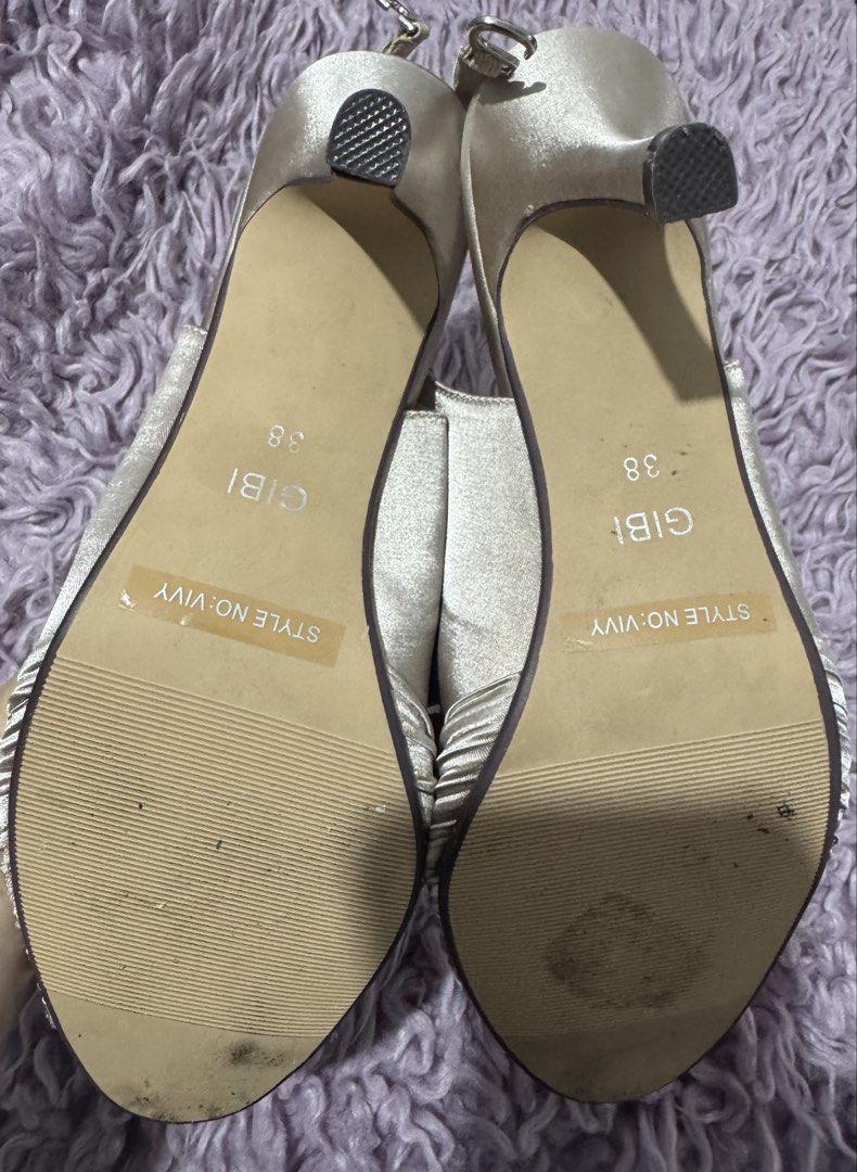 Gibi Gold Satin Slingback Heels Size 38 (Category: Heels) located in Cabanatuan. Submitted by dyosasalupa (Listing ID 1470507875, Image 2). Description: - Brand: Gibi - Style: VIVY (Gold Satin Slingback Heels) - Size: 38 (marked on sole) - Design: Ruched toe strap with a center sparkly rhinestone buckle - Features: Adjustable slingback strap with silver-toned hardware, stiletto heel with black protective tips - Condition: Clean insoles and textur