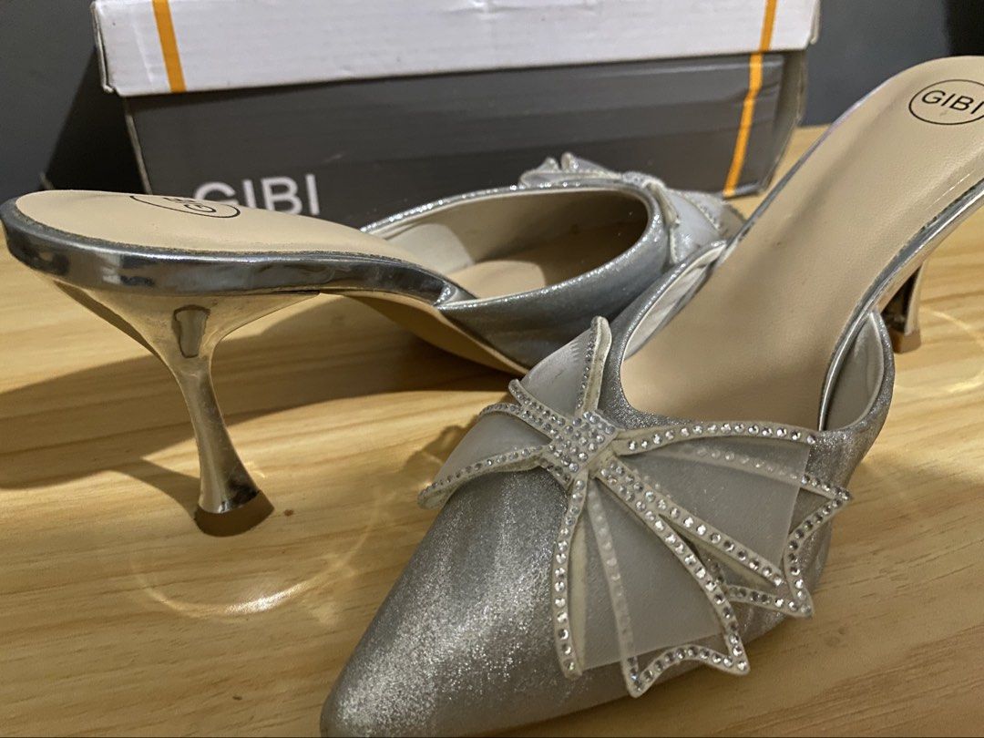 Gibi Silver Glitter Heels with Rhinestone Bow (Category: Heels) located in Makati City. Submitted by oncejjang (Listing ID 1470379890, Image 2). Description: - Brand: Gibi - Style: Pointed-toe high stiletto heels / slip-on mule design - Color/Finish: Silver glitter with sheer mesh bows and rhinestone detailing - Size: 39 - Condition: Great for parties, events, and formal wear.