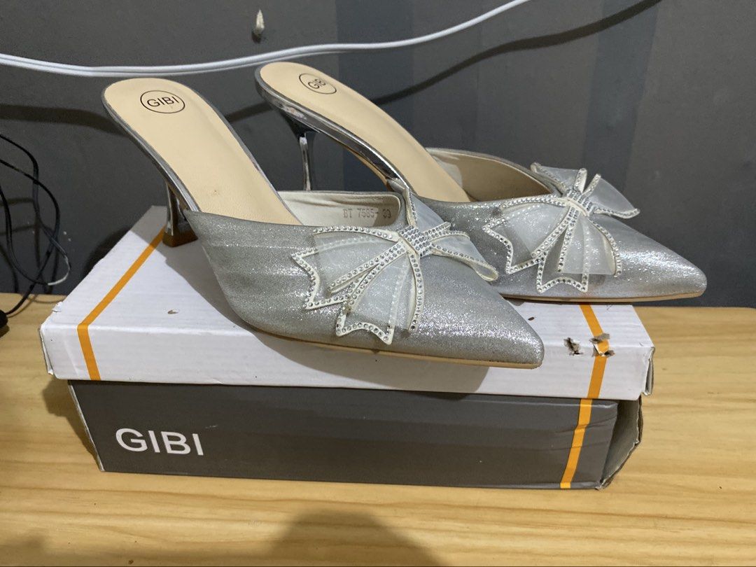 Gibi Silver Glitter Heels with Rhinestone Bow (Category: Heels) located in Makati City. Submitted by oncejjang (Listing ID 1470379890, Image 1). Description: - Brand: Gibi - Style: Pointed-toe high stiletto heels / slip-on mule design - Color/Finish: Silver glitter with sheer mesh bows and rhinestone detailing - Size: 39 - Condition: Great for parties, events, and formal wear.